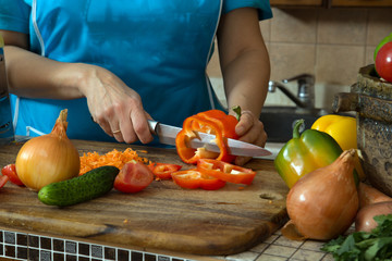 Woman cutting vegetables in the kitchen