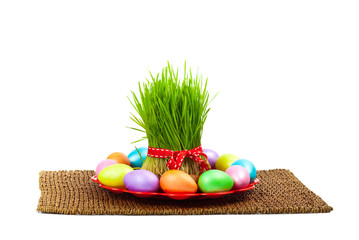Colored eggs, wheat springs on Nowruz holiday on white background. Selective focus.