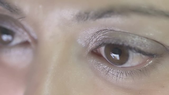 female eyes that read on smartphone