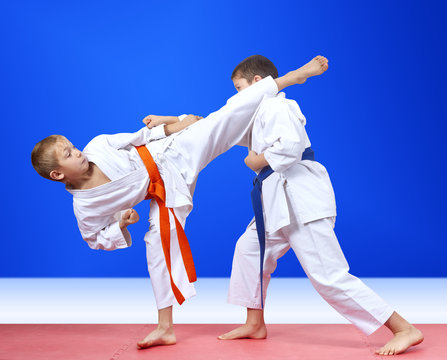 Children in karategi are training the punch arm and blow leg