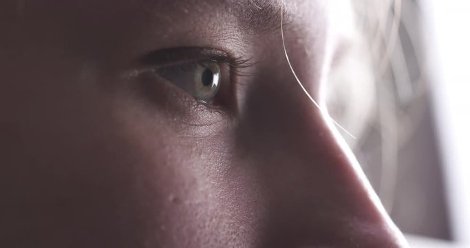 Closeup slow motion of teenage girl without makeup looking or watching something, 4k 60fps prores footage