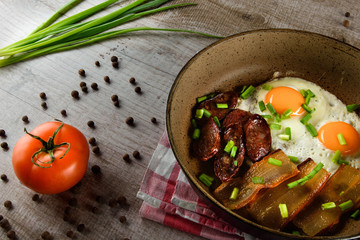 Ukrainian light breakfast. Breakfast in the pan on a wooden background