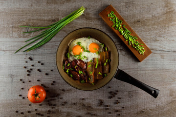 Ukrainian light breakfast. Breakfast in the pan on a wooden background