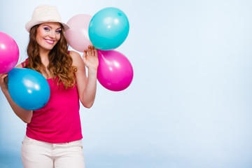 Fototapeta premium Woman playing with many colorful balloons