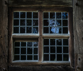 The  window of an old,wooden farmhouse