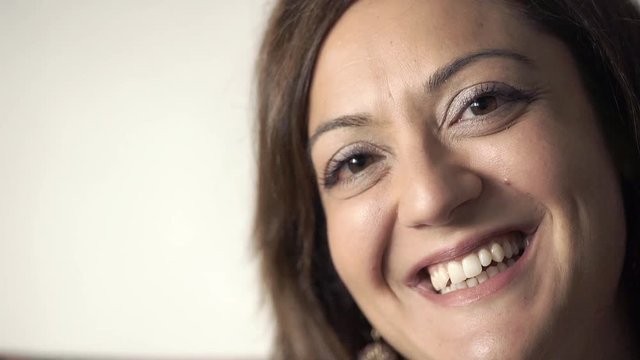 dark-haired woman laughs heartily