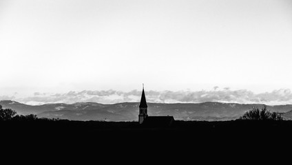 Church silhouette on mountains background