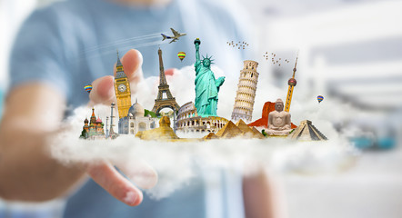 Businessman touching a cloud full of famous monuments with his f