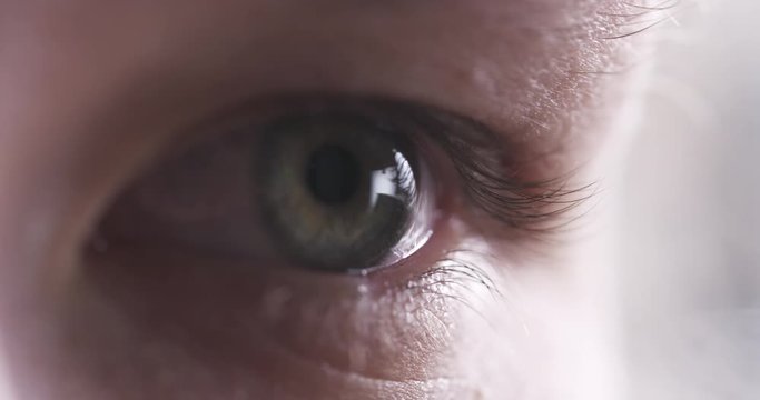 Closeup slow motion of teenage girl eye without makeup looking or watching something, 4k 60fps prores footage