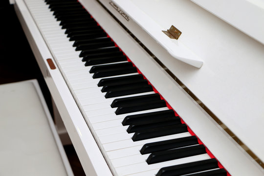 Close-up white piano, white and black keyboard