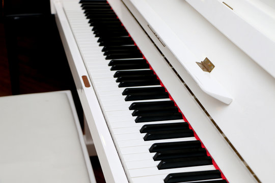 Close-up white piano, white and black keyboard