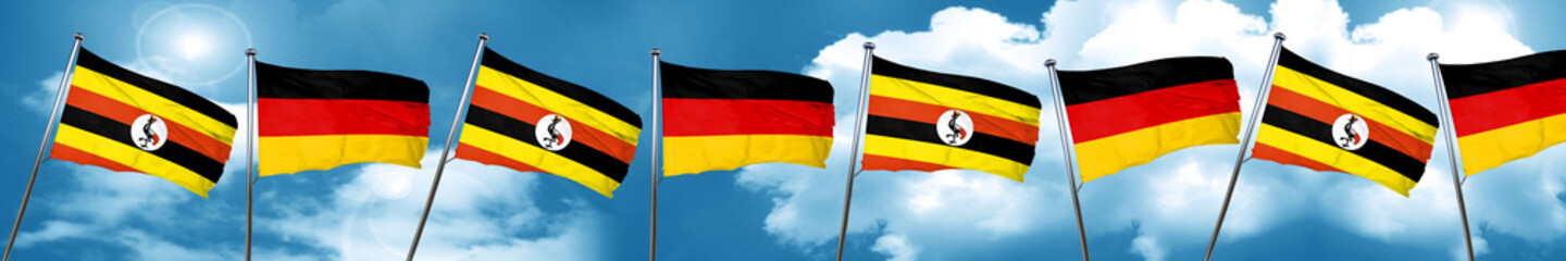 Uganda flag with Germany flag, 3D rendering