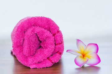 pink towel and frangipani flower