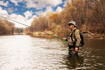 Grayling fishing on the river in autumn