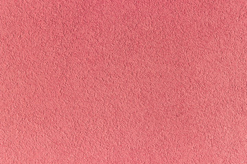 Pink background. Decorative external plaster. Exterior and interior finish of walls. Texture