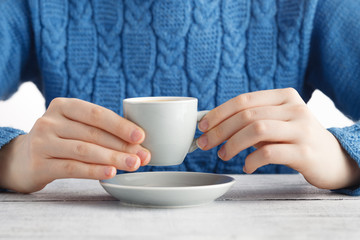 girl drink espresso coffe from small cup