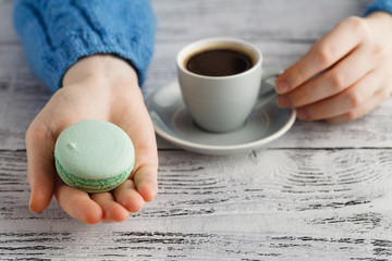 drink coffee and hold macaroon