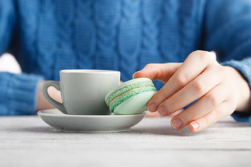 drink coffee and hold macaroon