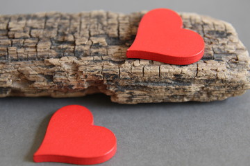 Valentines day. Red hearts on gray background. Wood