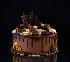 Birthday cake decorated with makarons, marshmallow and marshmallow.