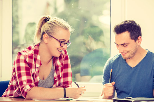 Two Students Talking In Classroom