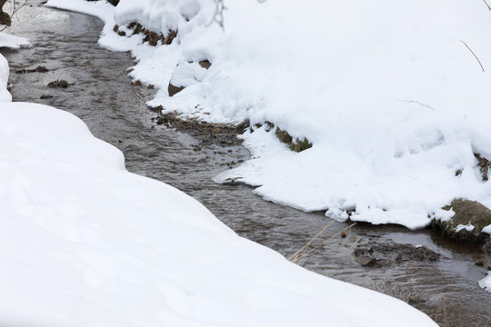 spring creek between coasts in snow