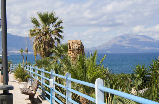 View of the mountains and the mediterranean from a coast walkway in Trappeto, Sicily, Italy
