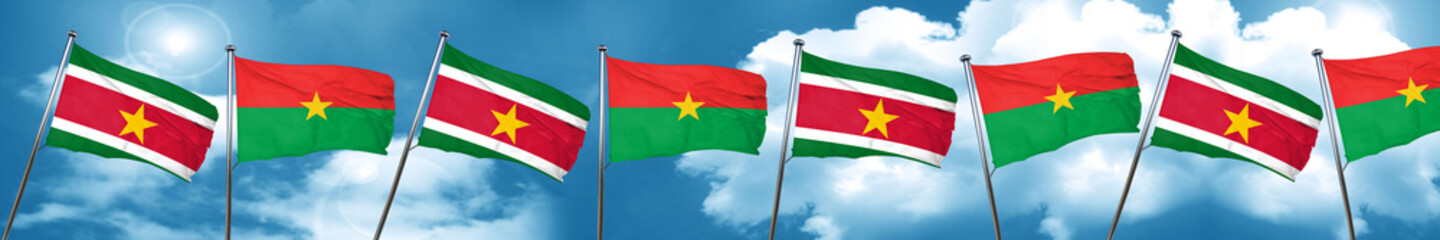 Suriname flag with Burkina Faso flag, 3D rendering
