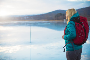 Woman looking over frozen lake