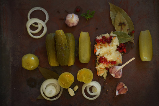 Pickles. Bowl of pickled gherkins cucumbers over rustic wooden background with copy space.