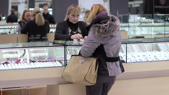 Adult woman buys jewelry and communicates with the seller