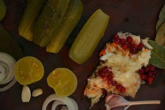 sauerkraut, cucumber pickles - popular probiotic fermented food - three measuring cups against rustic wood