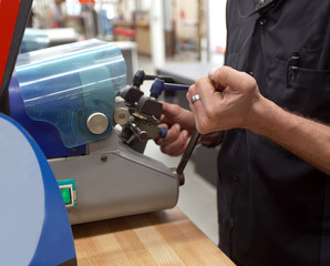 Key maker copying key.