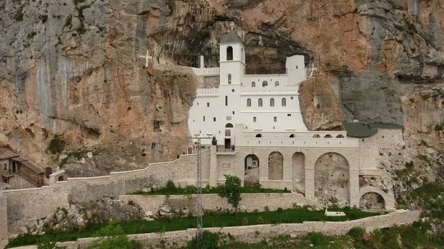 Buildings cut in cliff of Ostrog Monastery (the Serbian Orthodox Church). Front view. Montenegro
