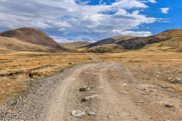 Beautiful mountain landscape with country road and blue sky wiht
