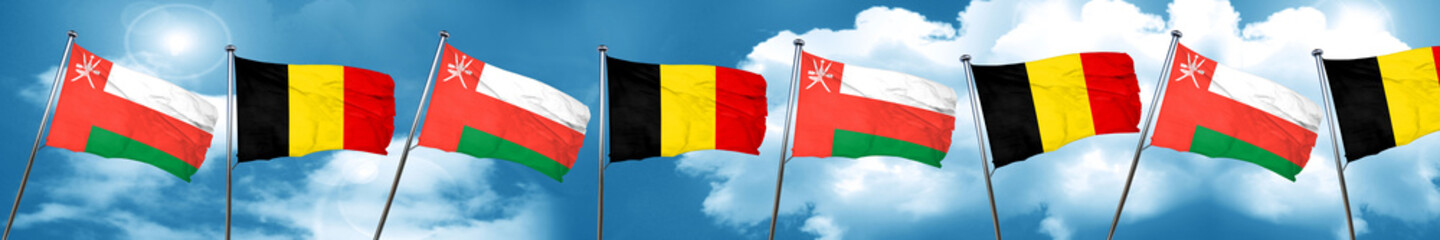 Oman flag with Belgium flag, 3D rendering