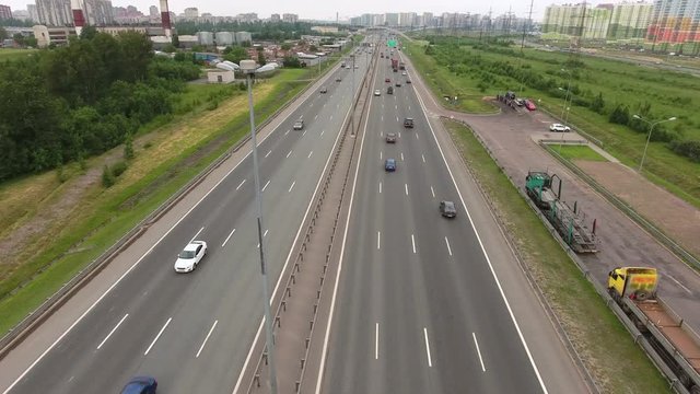 Day road traffic at the Saint Petersburg Ring Road. Orbital freeway encircling at the north of city. Aerial view. Russia
