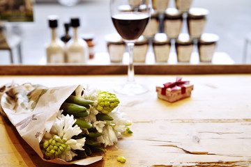 bouquet of hyacinths on wooden table in cafe in front of window. St. Valentine's day