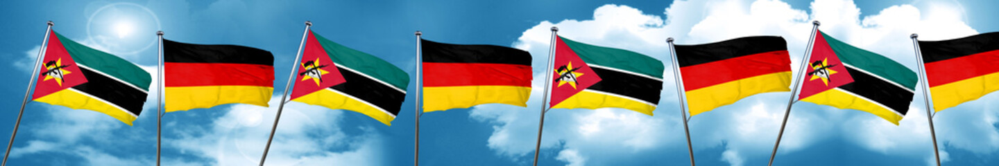 Mozambique flag with Germany flag, 3D rendering