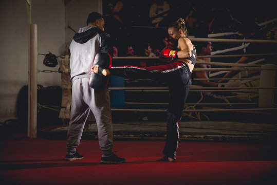 Woman martial artist sparring with her coach