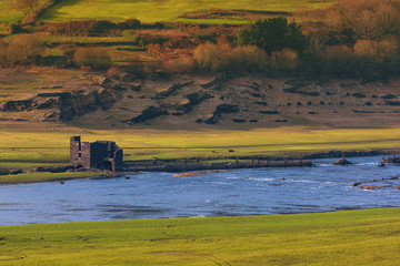 Fototapeta premium Ruins of an old house in San Estevo water reservoir. The house is generally submerged by the waters of Miño river