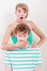surprised couple wide eyed girl covering mouth her man