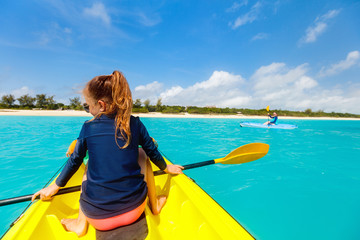 Family kayaking at tropical ocean