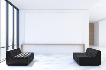 Waiting area with black sofas