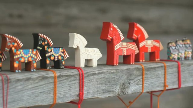 Colorful russian traditional wooden horses toy with thread at Shrovetide festival