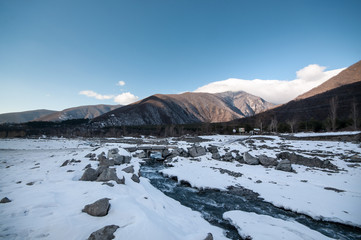 Fototapeta na wymiar Beautiful Landscape of snowy winter greater Caucasus mountains. Sunny weather, trees clouds fields of Azerbaijan nature
