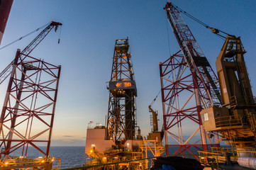 Fototapeta na wymiar Offshore jackup drilling rig's legs with view of derrick and crane in background.