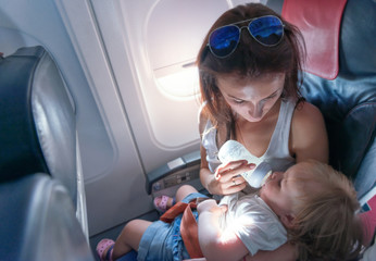  Mother feeding her baby at a airplane