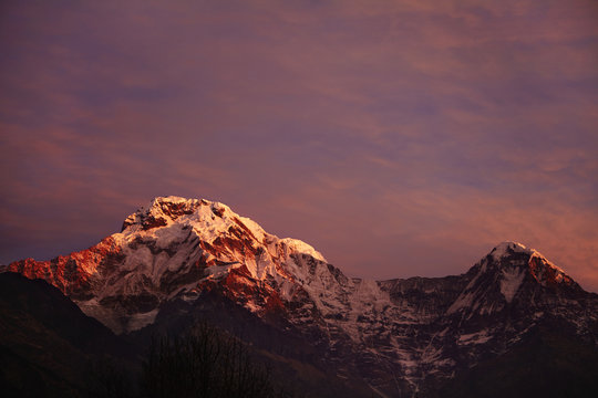 Amazing breathtaking view of sunset over craggy summits of the Himalayan mountain range. Scenery of icy peaks of majestic ancient mountains standing high above valley in the Annapurna Sanctuary © Wayhome Studio