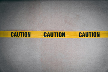 Yellow CAUTION tape barring entrance with added grain